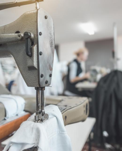 clothing industry workers working on sewing machines workers working on sewing machines in clothing industry
